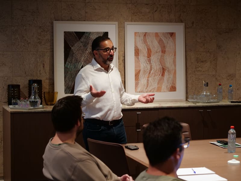 An HVL facilitator presenting to executives around the boardroom table